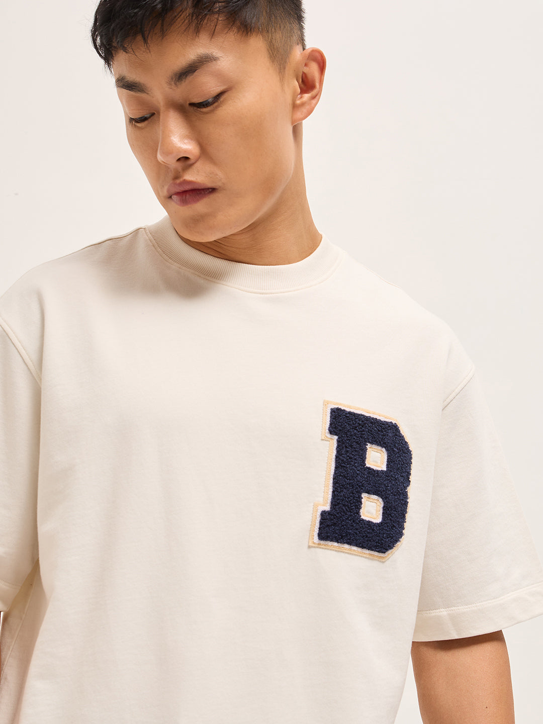 White Oversized Graphic T-Shirt with Chenille Patch and Bold Back Print