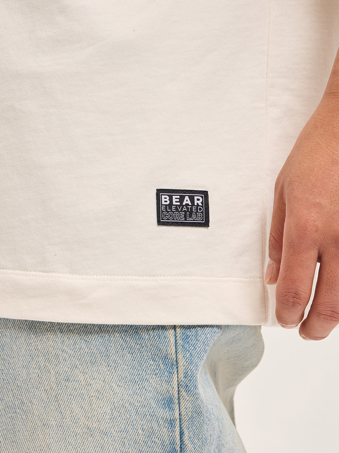 White Oversized Graphic T-Shirt with Chenille Patch and Bold Back Print